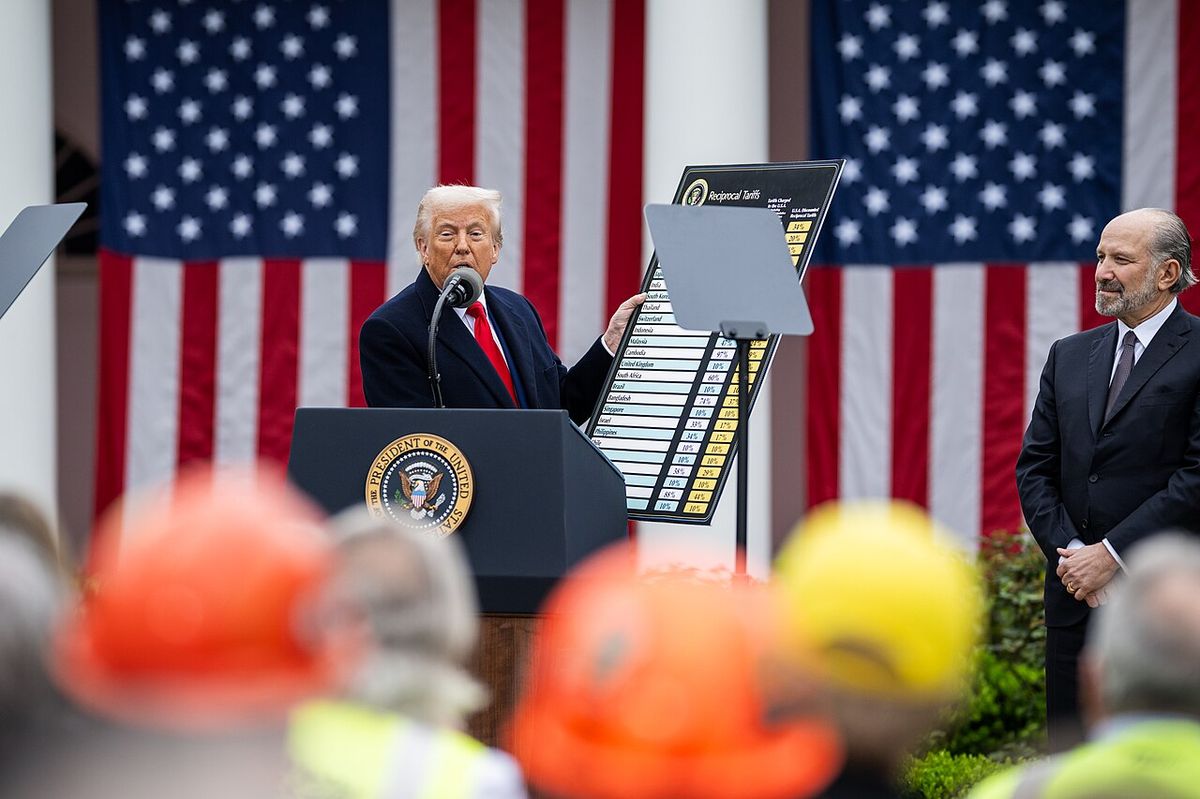 Trump holds up his “Reciprocal Tariffs” chart in the Rose Garden as Commerce Secretary Lutnick looks on, April 2, 2025.